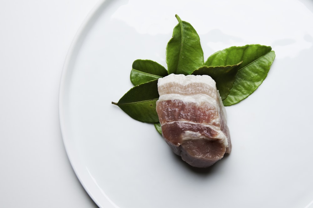 raw meat on white ceramic plate