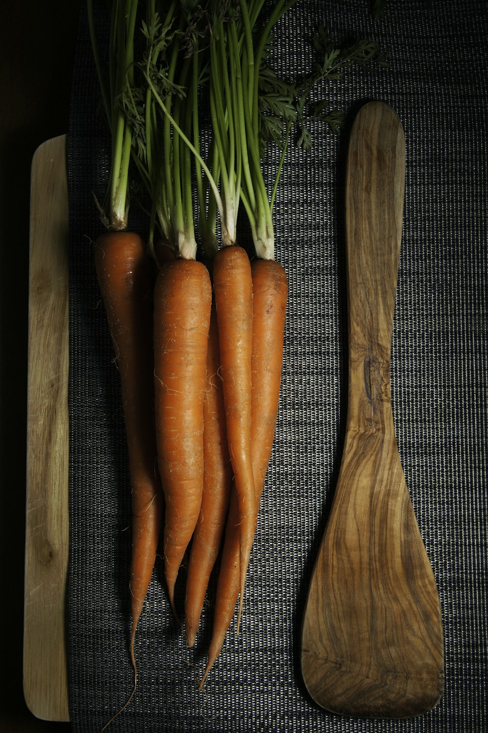 orange carrots on brown wooden chopping board