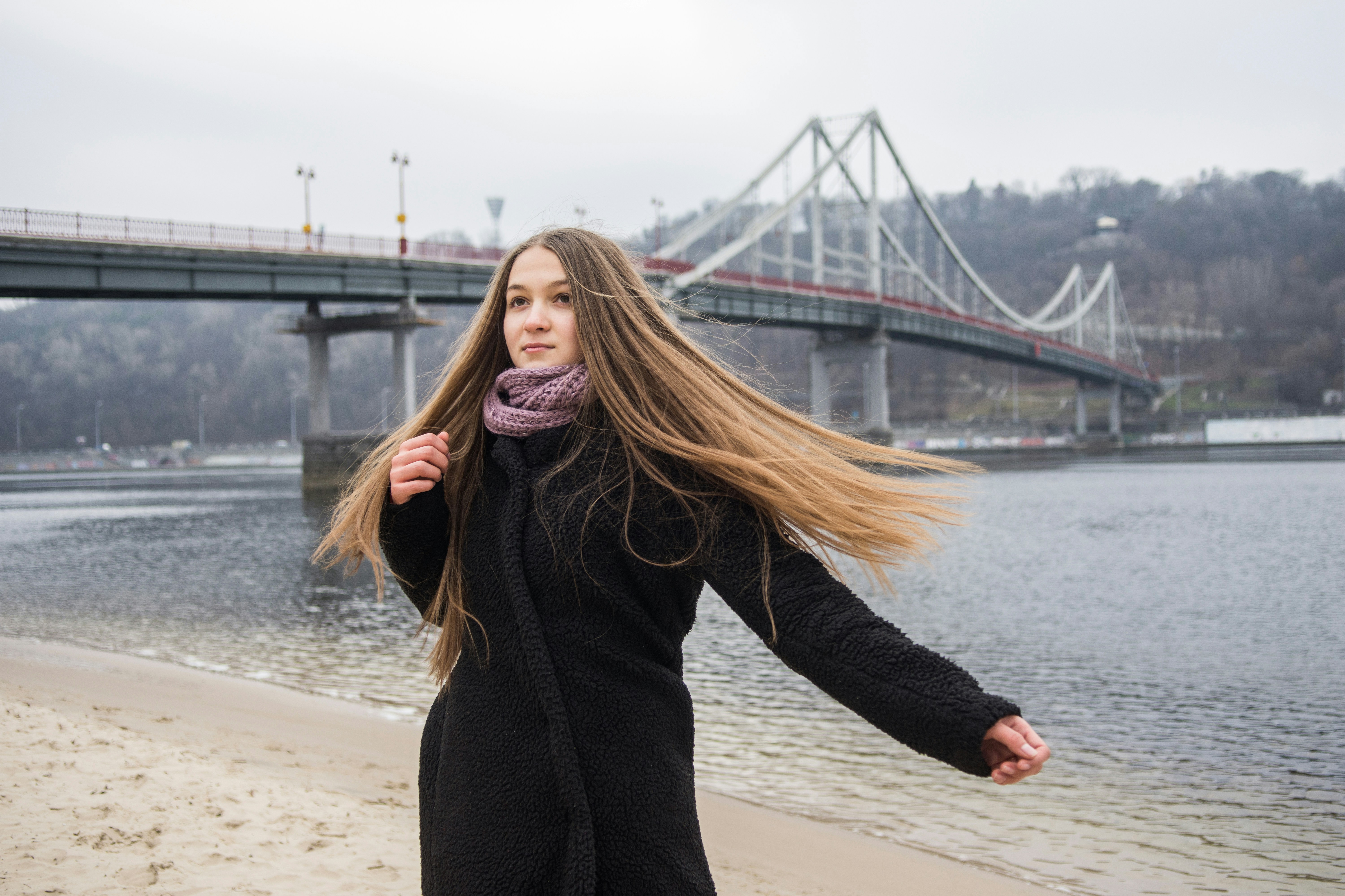 woman in black long sleeve shirt standing on beach during daytime