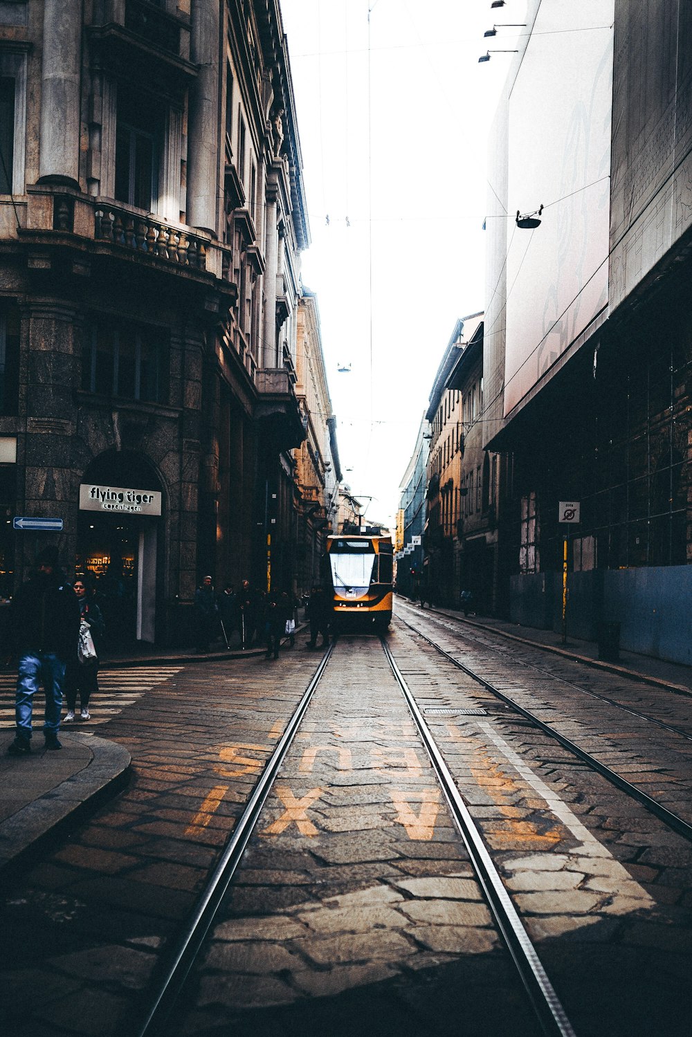 people walking on street beside buildings during daytime