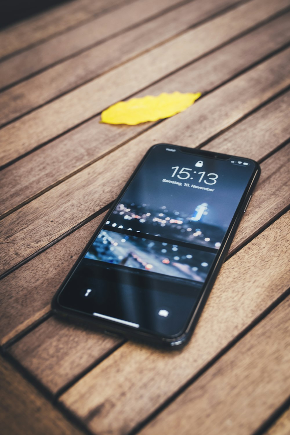 black iphone 5 on brown wooden table