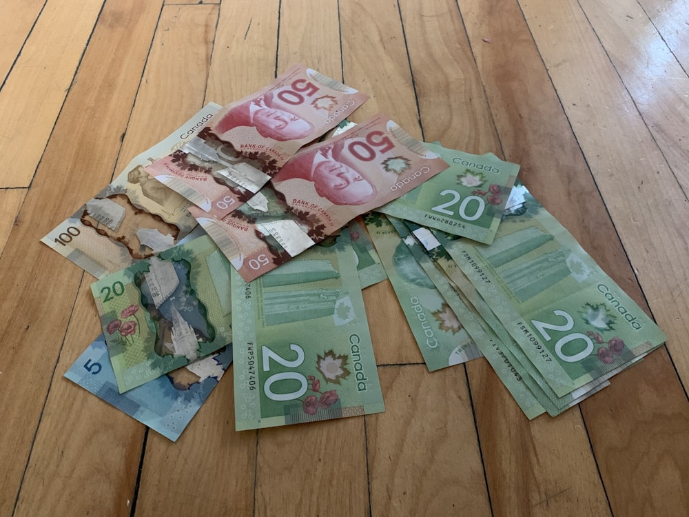 10 and 20 banknotes on brown wooden table