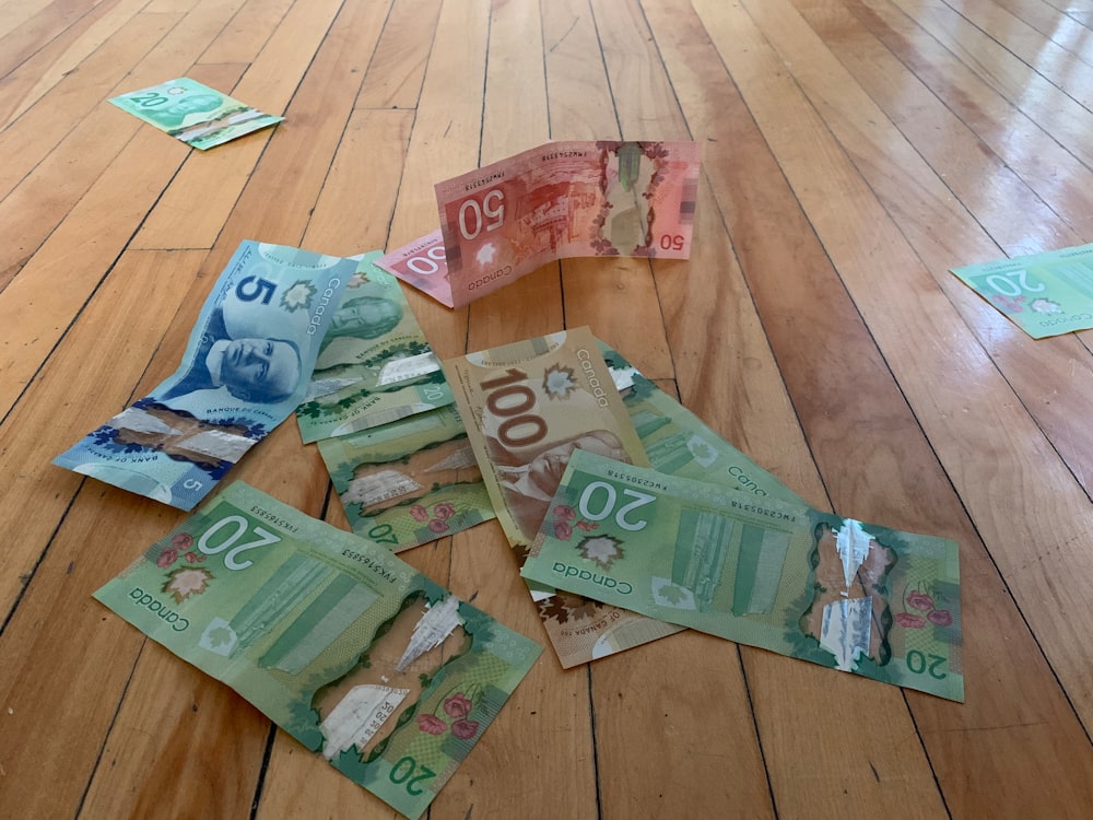 10 and 20 banknotes on brown wooden floor