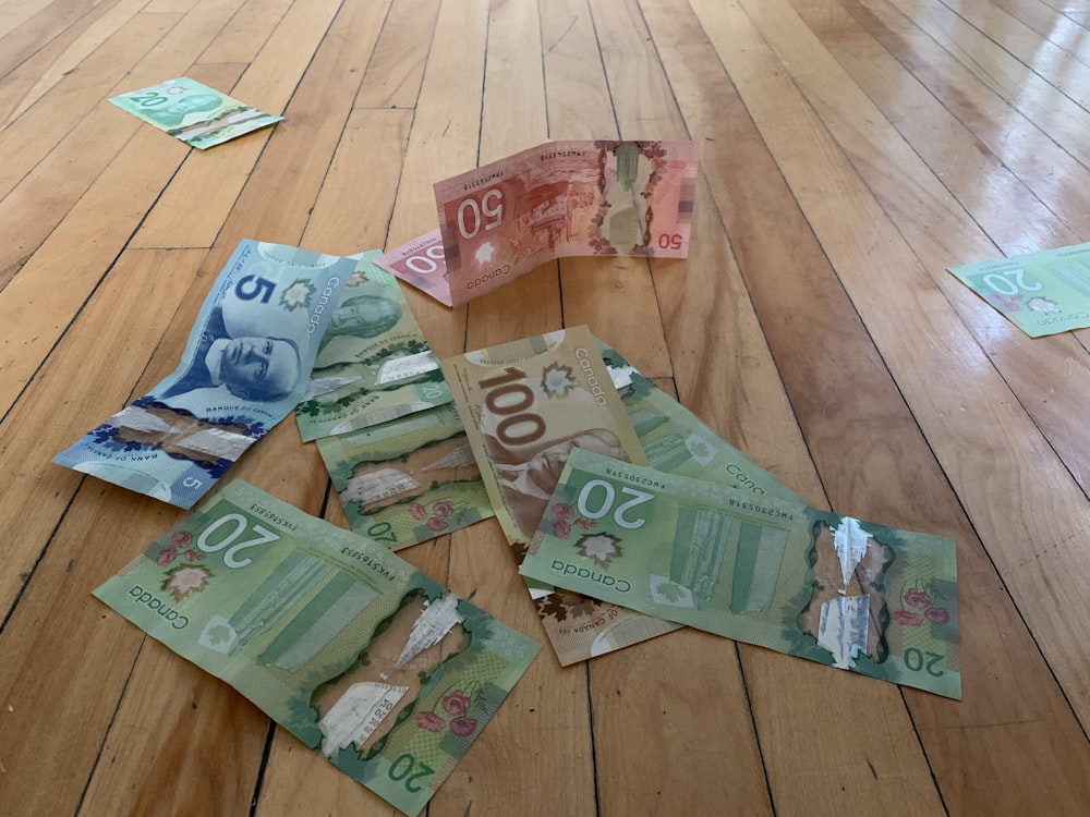 10 and 20 banknotes on brown wooden floor