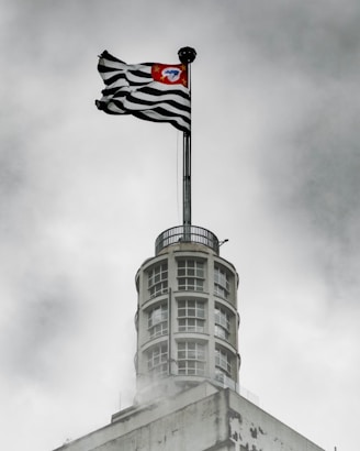 us a flag on top of gray concrete building