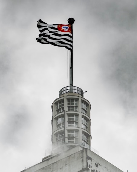 us a flag on top of gray concrete building