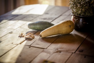 A warm autumn salad featuring roasted squash, kale, and toasted nuts on a rustic wooden table.