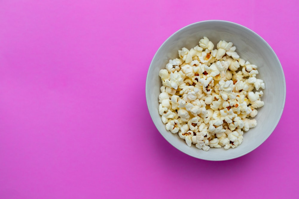 white ceramic bowl on pink textile