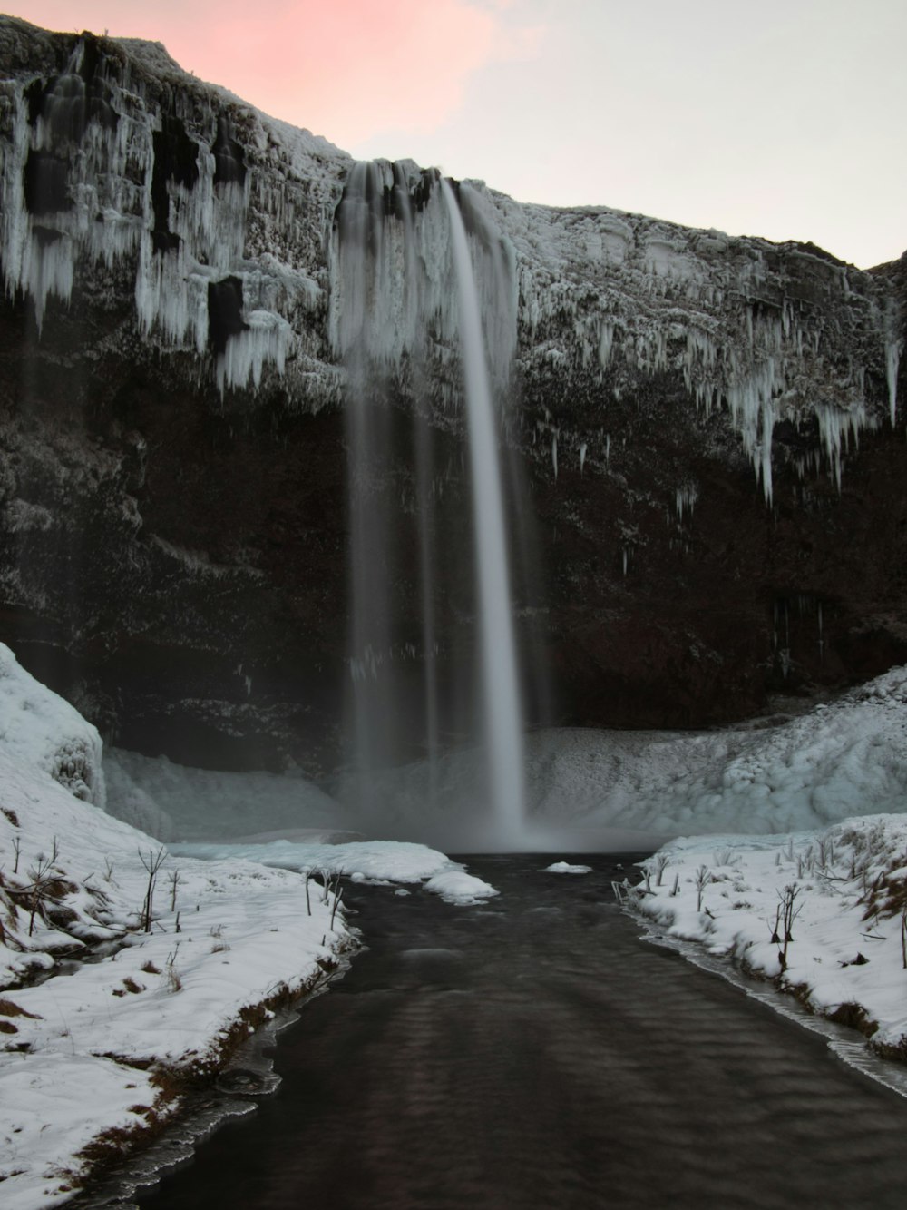 water falls on snow covered ground