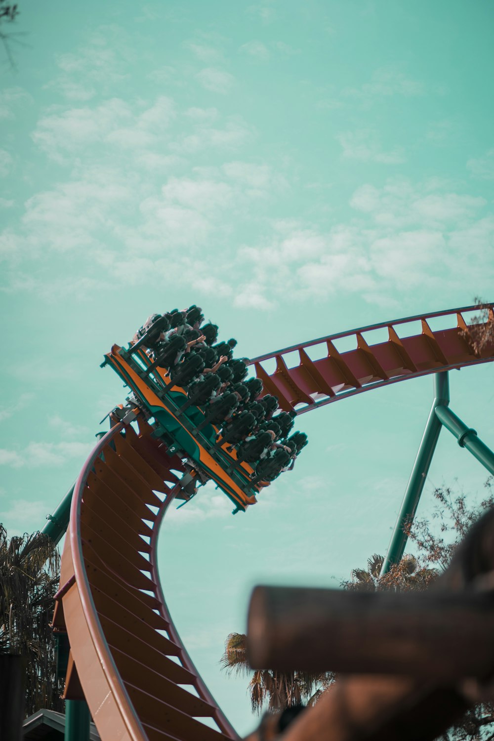 people riding roller coaster during daytime