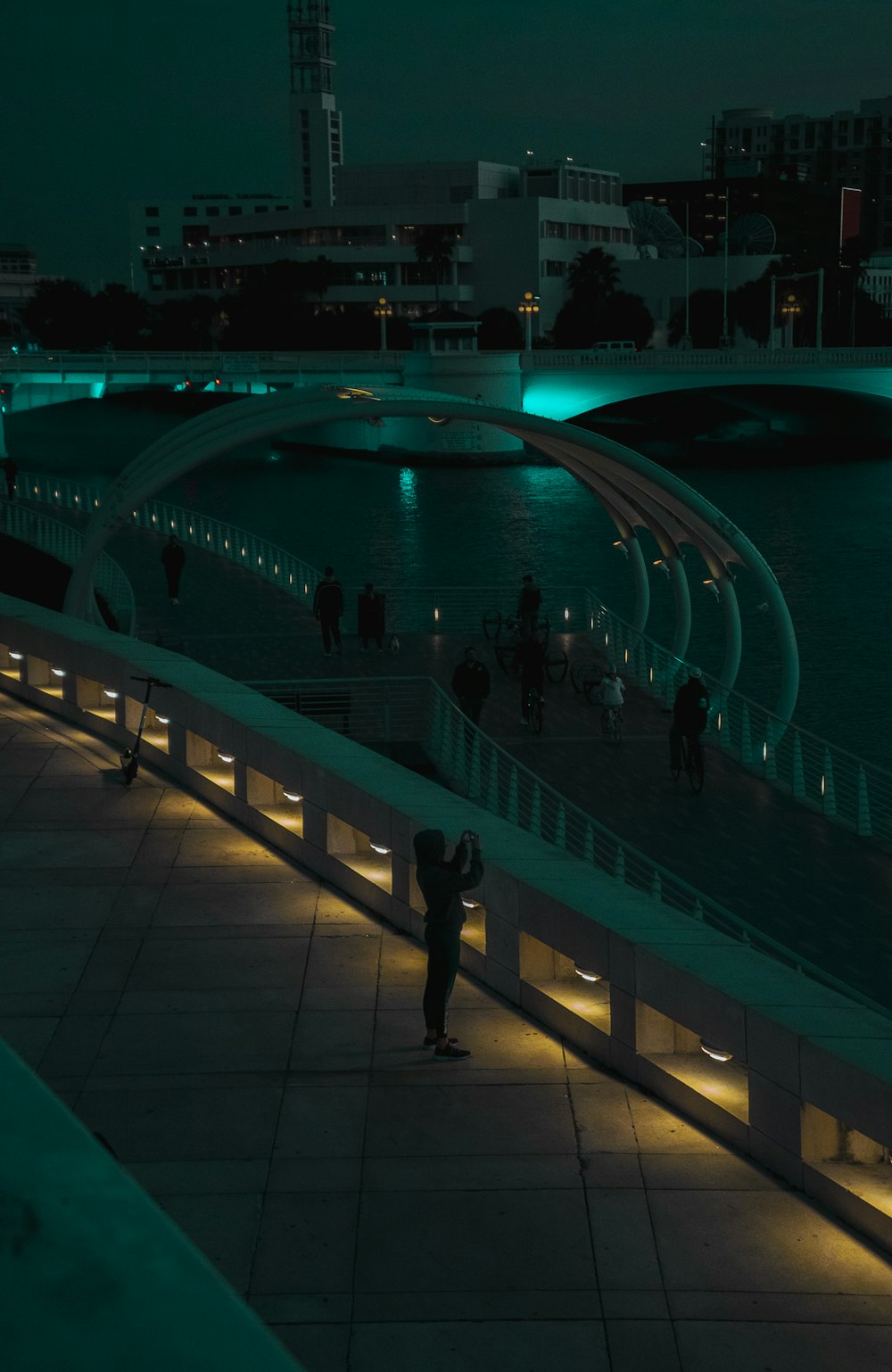 people walking on swimming pool during night time