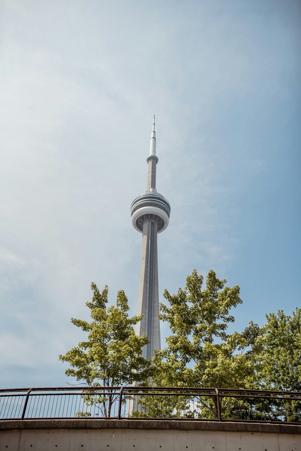 white and gray tower under white clouds during daytime