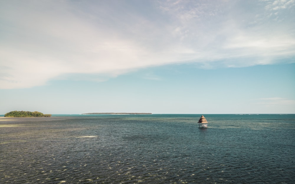 2 people riding on boat on sea under blue sky during daytime