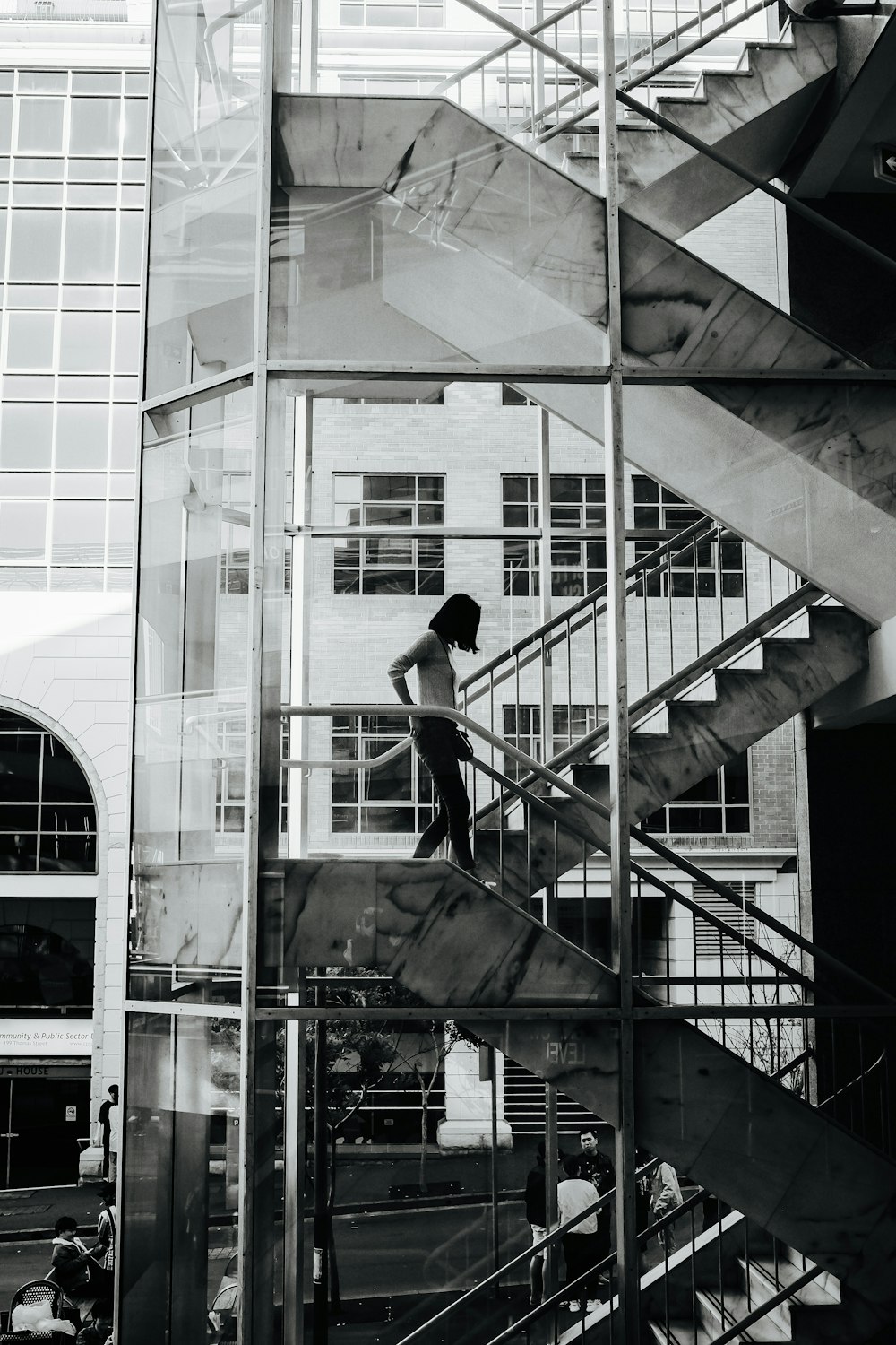 man in black jacket and pants standing on black staircase