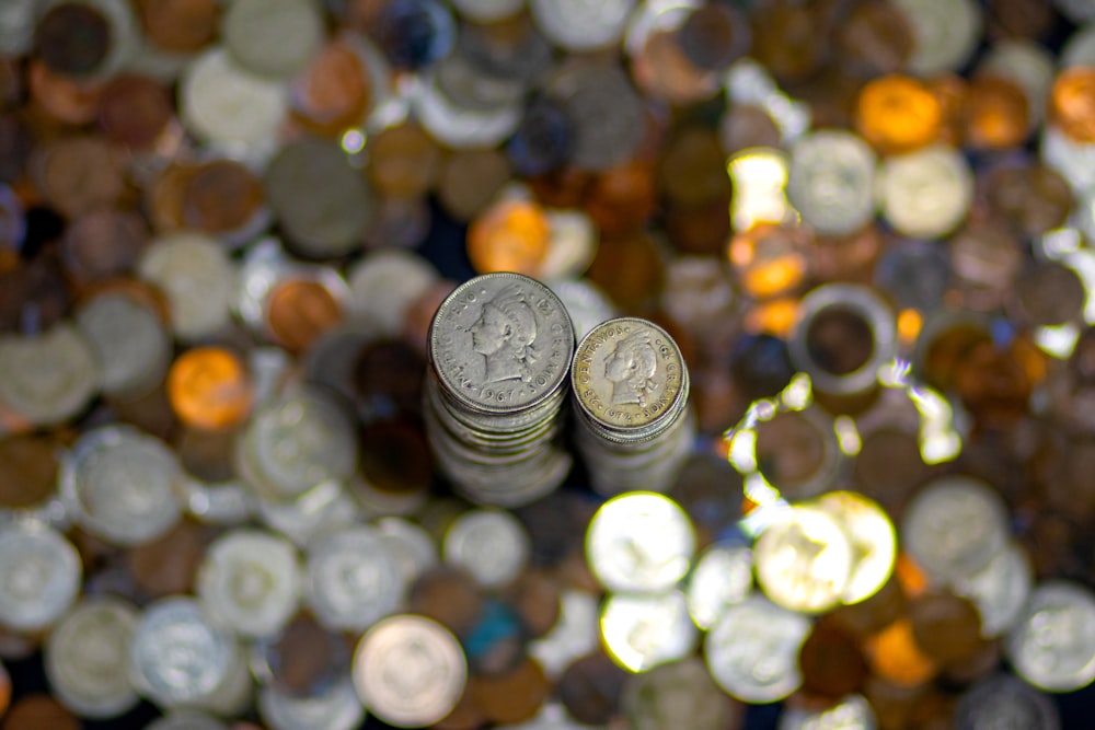 silver round coins on brown wooden table