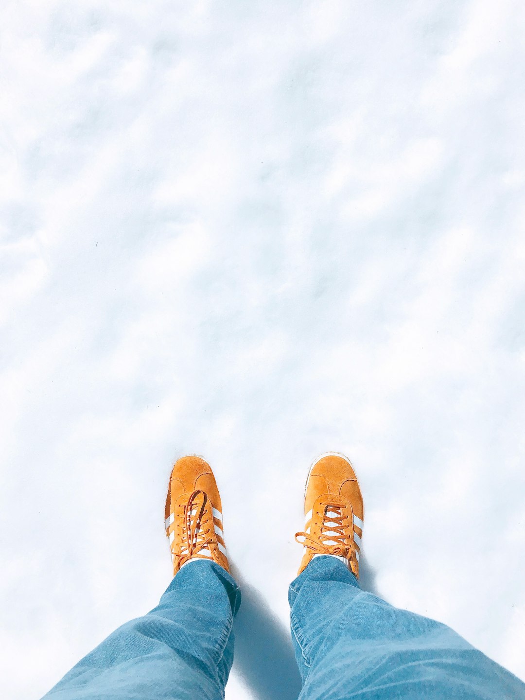 person in blue denim jeans and brown shoes