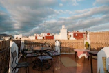 Sunlit terrace of a Casablanca riad overlooking the city skyline.
