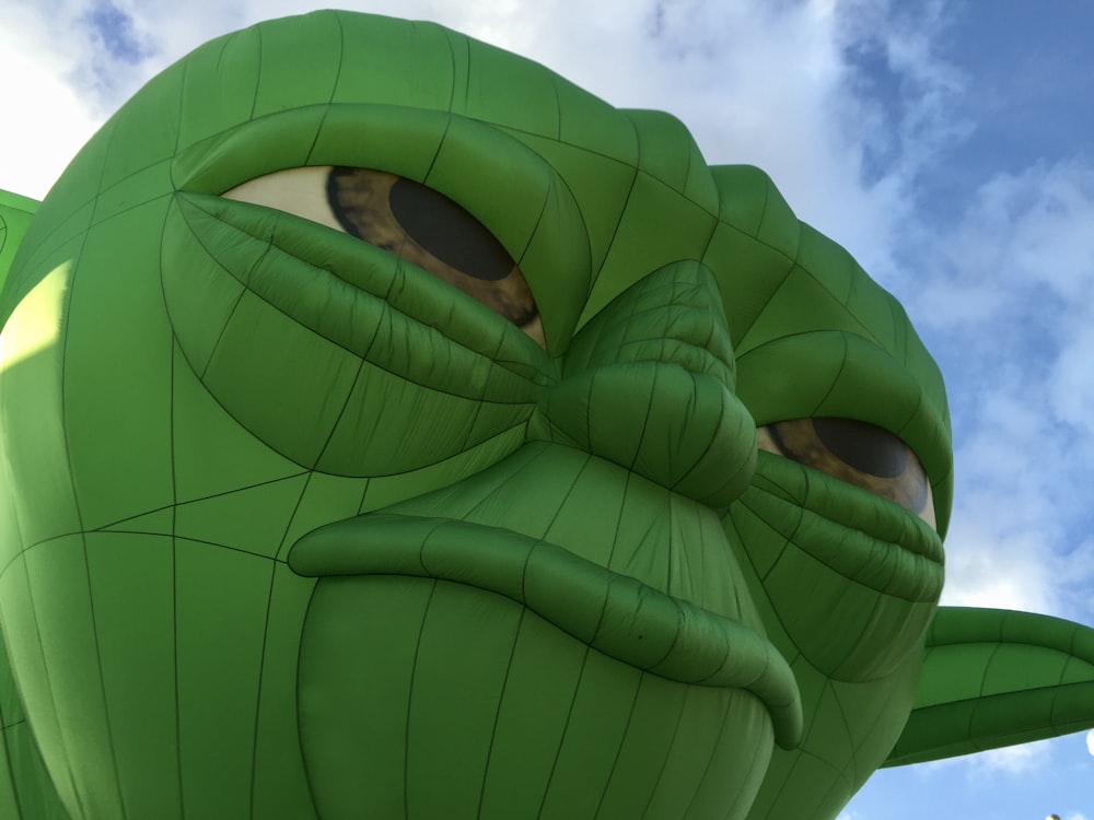 green and black parachute under blue sky during daytime