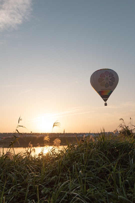 hot air balloon flying over the field during daytime in Saga Japan