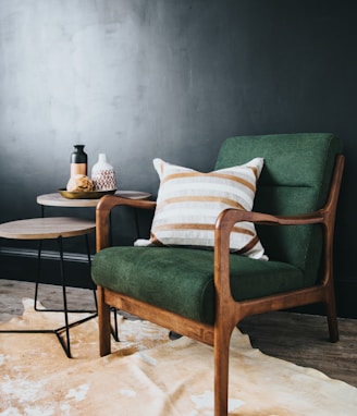 white throw pillow on green sofa chair