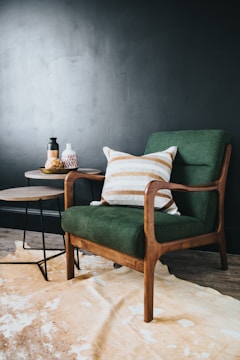 white throw pillow on green sofa chair