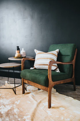 white throw pillow on green sofa chair