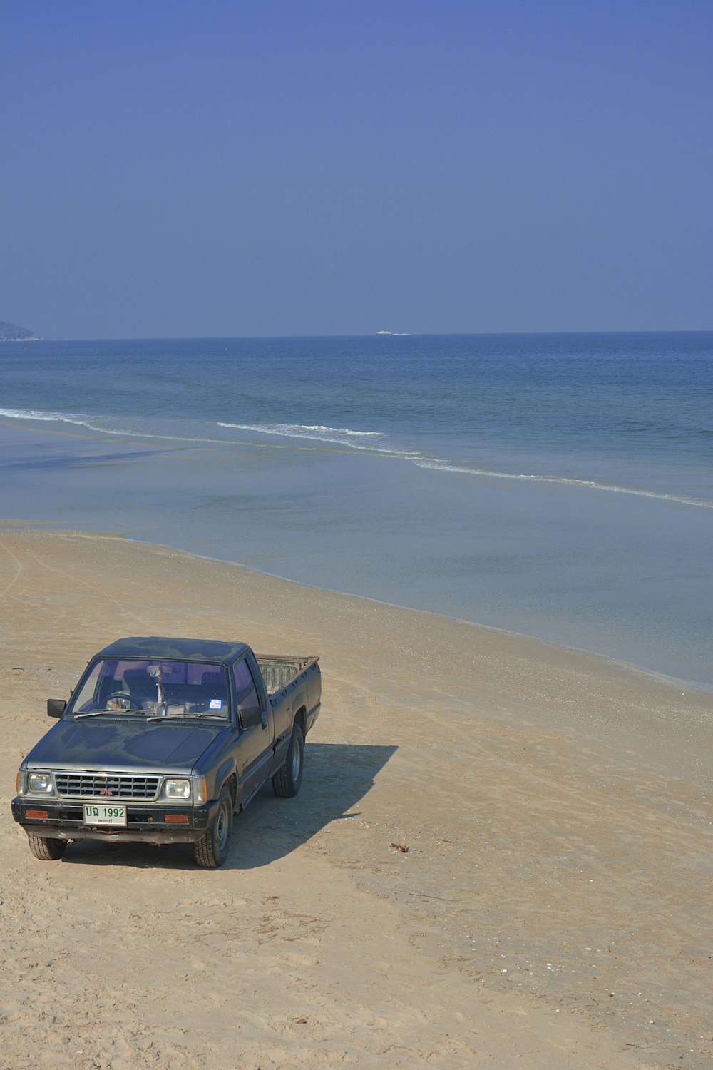 black car on beach during daytime