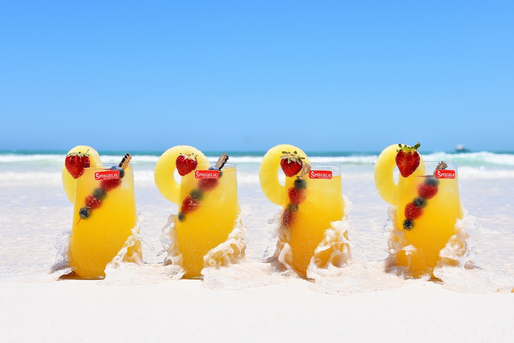 yellow ice cream on white sand during daytime