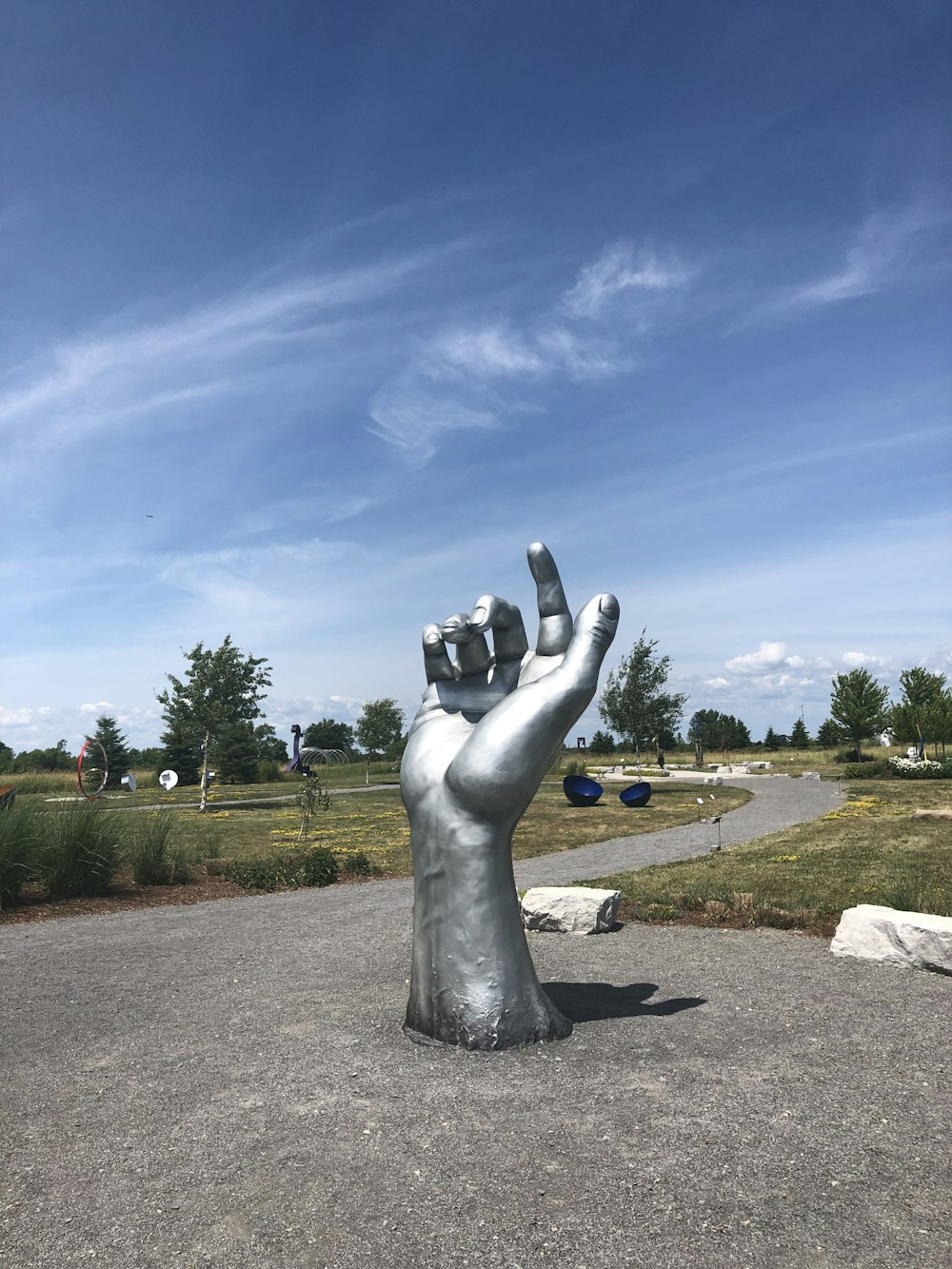 gray statue on brown soil under blue sky during daytime