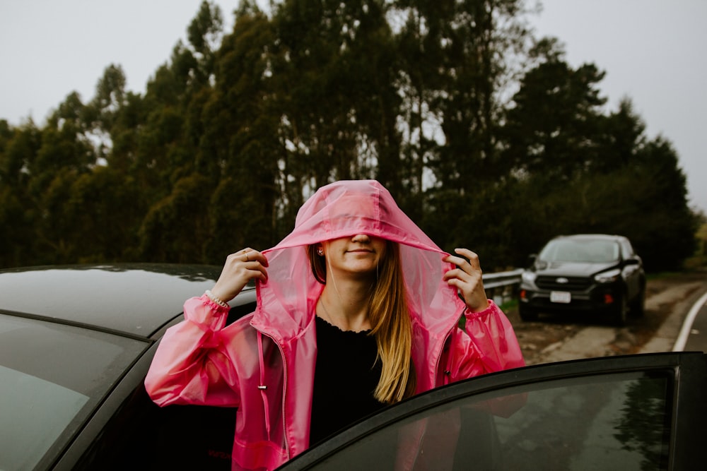 woman in pink hijab holding pink scarf