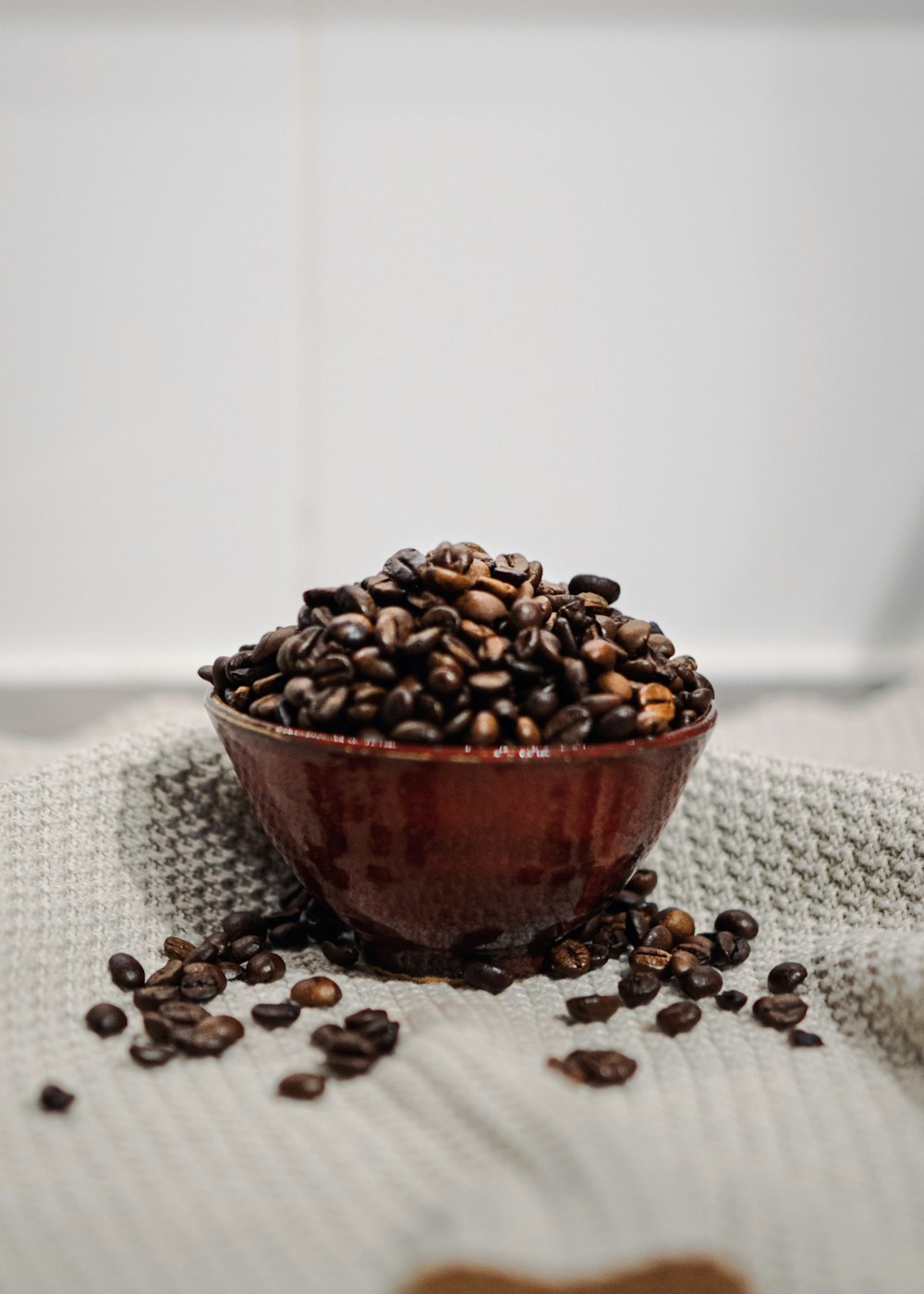 brown coffee beans on brown ceramic bowl