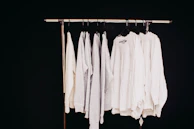 white dress shirt hanging on clothes hanger
