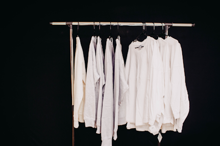 white dress shirt hanging on clothes hanger