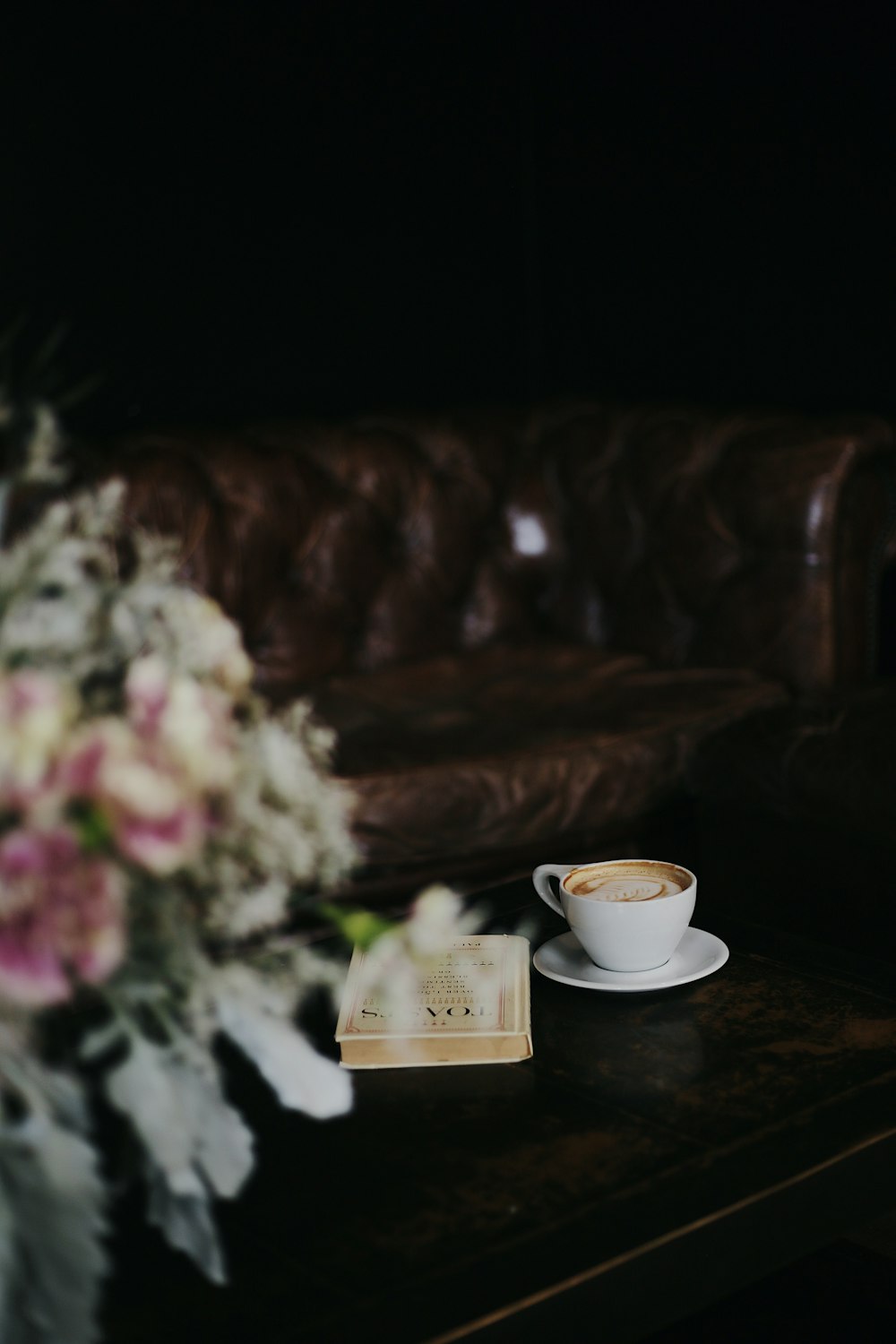 white ceramic teacup on brown wooden table