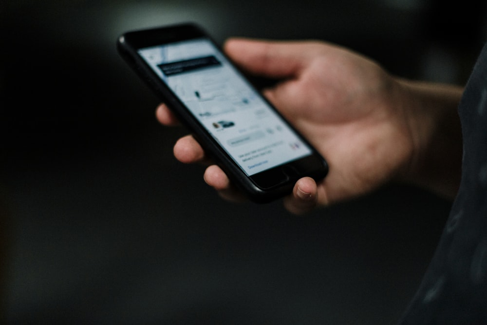 person holding black iphone 5