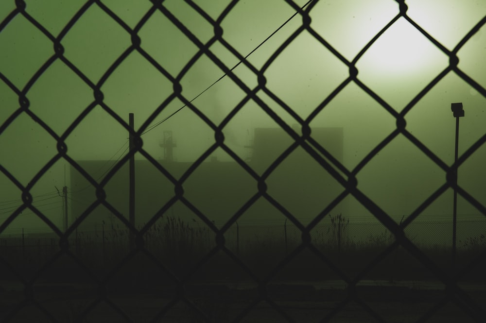 black metal fence with chain link fence