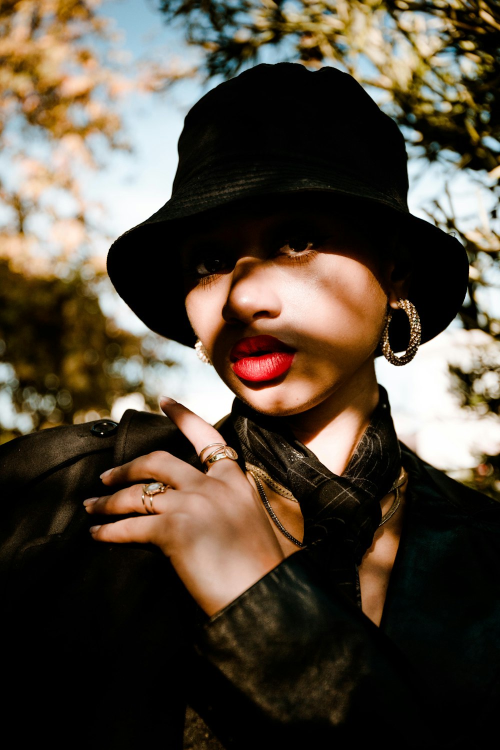 woman in black leather jacket wearing black hat