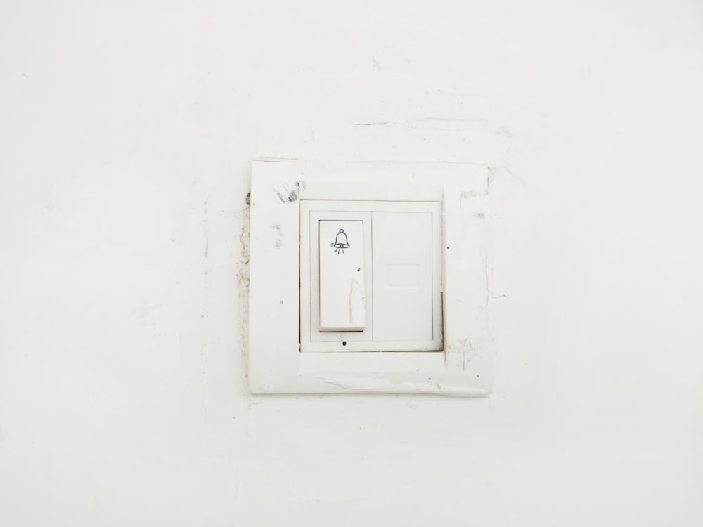 white switch mounted on white painted wall