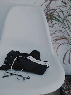 A close-up of the sleek millionaire scholar kim black t-shirt laid neatly on a rustic wooden table.