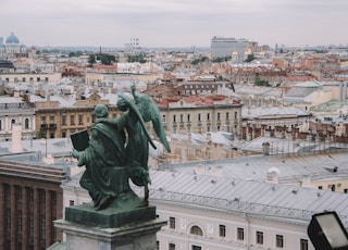 green statue on top of building during daytime