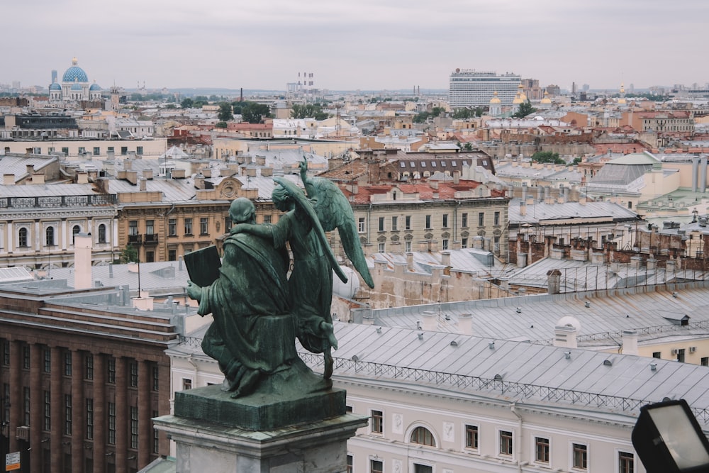 green statue on top of building during daytime