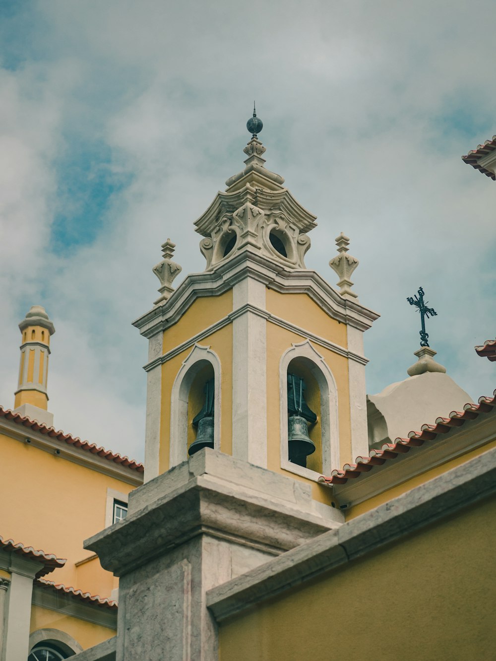 white and brown concrete church under white clouds