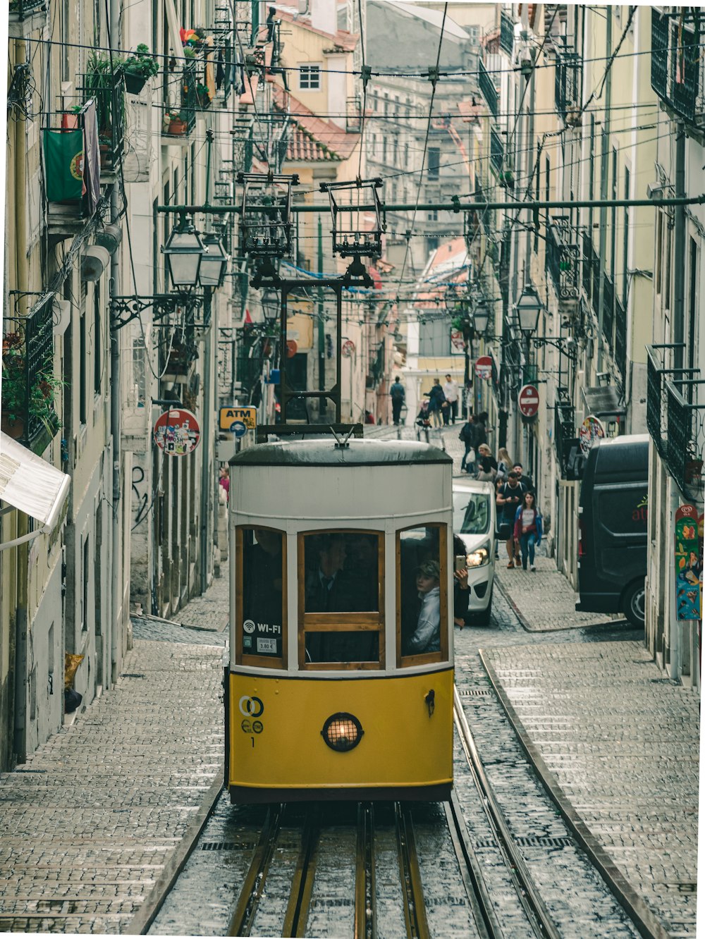 yellow and white tram on street during daytime