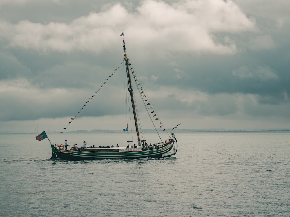 blue and white boat on sea under cloudy sky during daytime