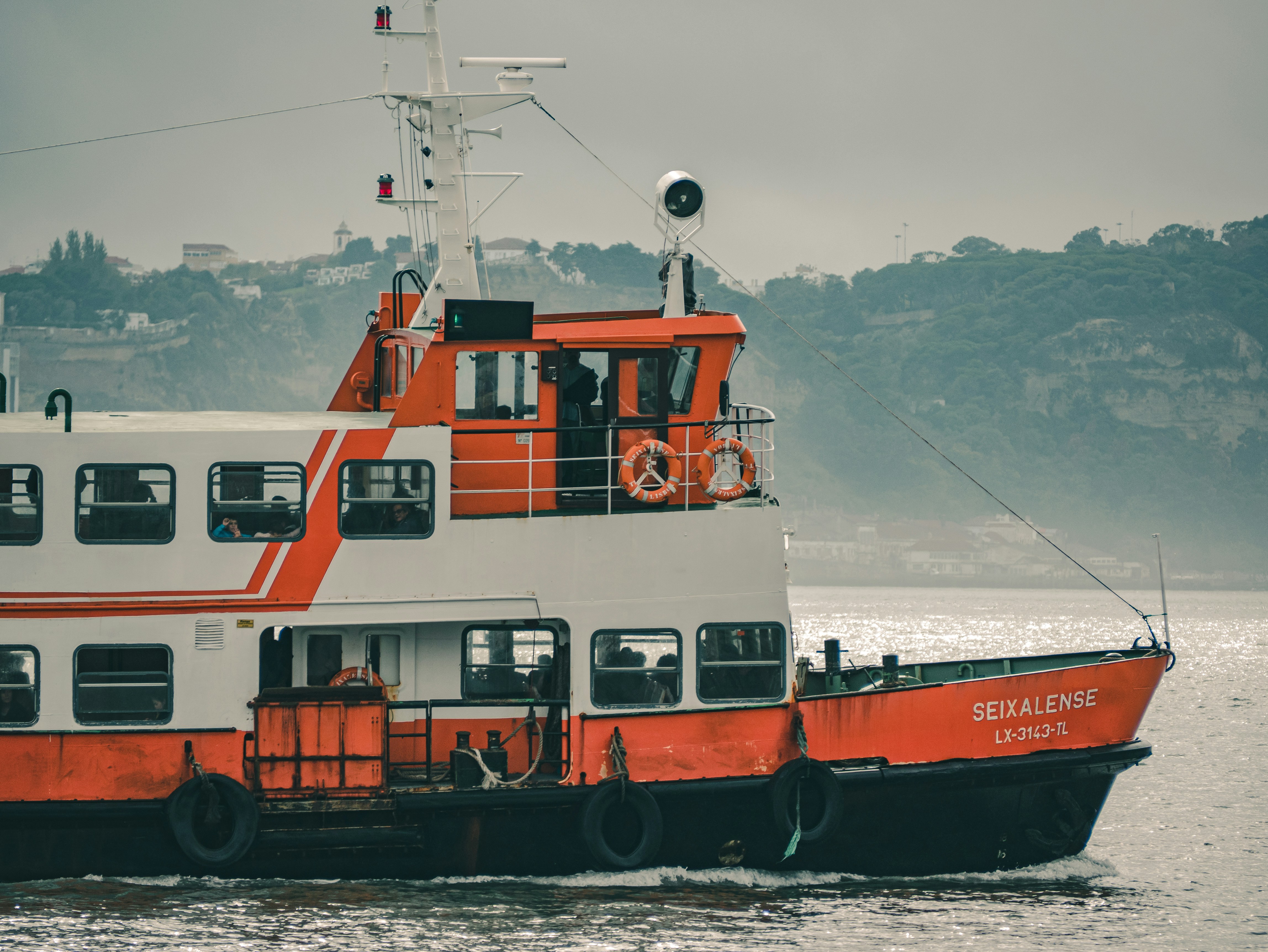 red and white boat on body of water during daytime