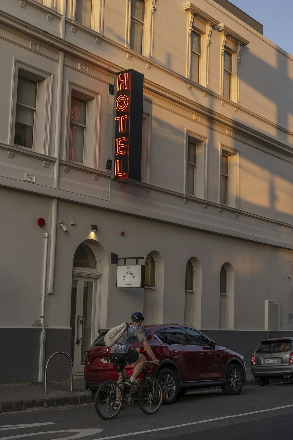 cars parked in front of white building during daytime