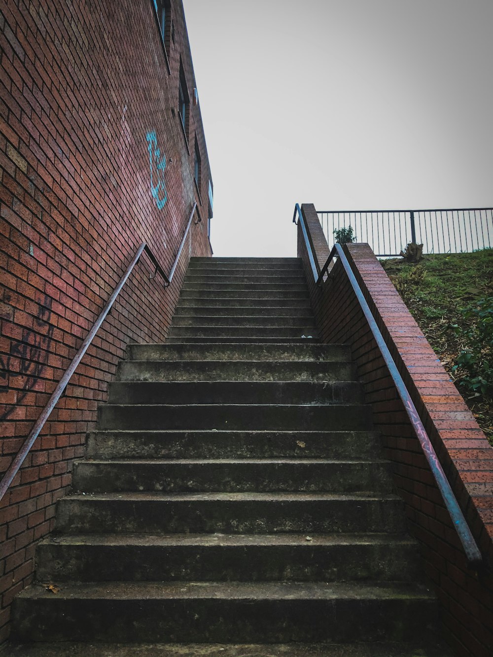 brown brick stairs with stainless steel railings