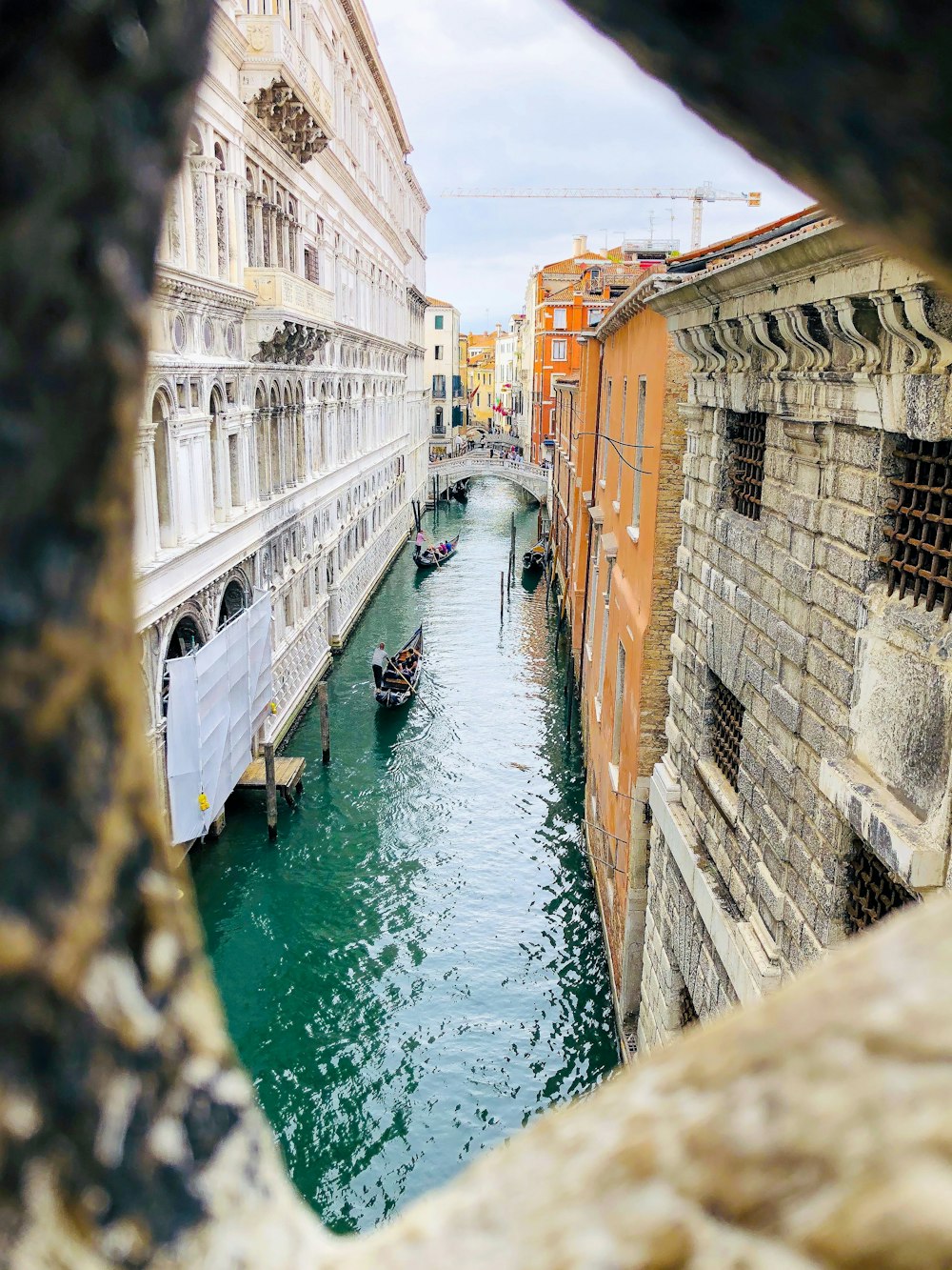 body of water between concrete buildings during daytime