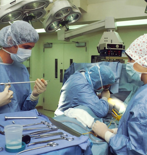 people in blue scrub suit sitting on chair