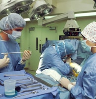 people in blue scrub suit sitting on chair